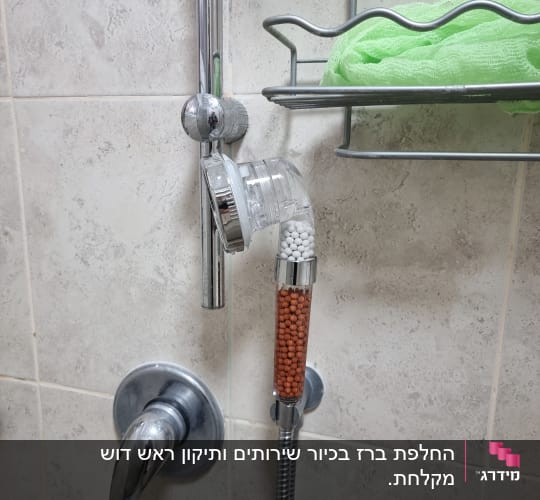 ראש מקלחת עם פילטרים על קיר אמבטיה